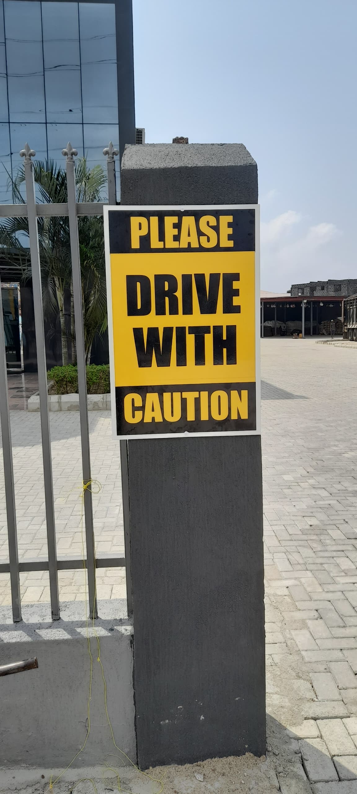 Drive With Caution Bollard Sign for Facility Client